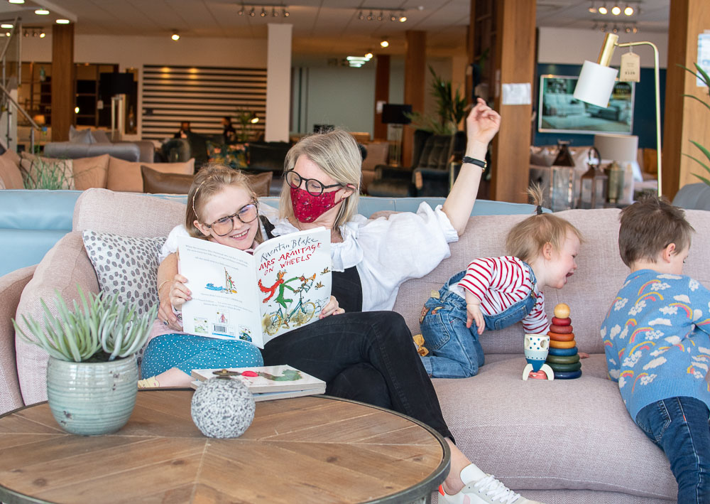 Karen, sustainable style blogger, with her family sat on the Pioneer eco friendly sofa by Sofaology